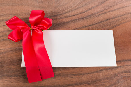 The white letter and a big ribbon on the wood backgroundの写真素材