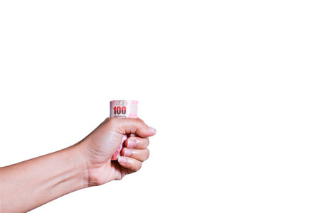 Thai cash  in Asian woman's hand on white background with clipping pathの写真素材