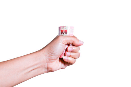 Thai cash  in Asian women's hand on white backgroundの写真素材
