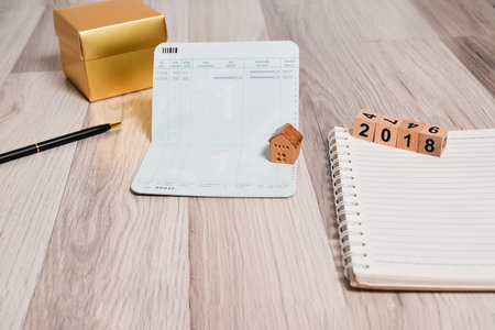The empty book bank with 2018 new year cubes and home model , finance planning  conceptの写真素材
