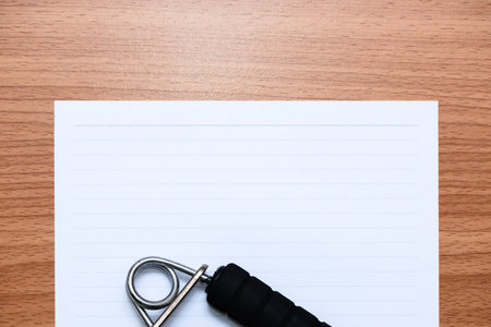 White line paper with sport equipments  on brown wooden table, top viewの写真素材