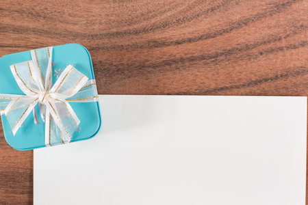 The white letter and a green gift box on wooden backgroundの写真素材