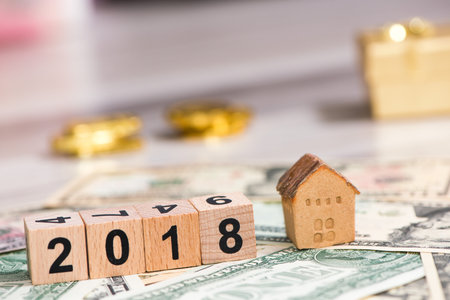 2018 new year cubes with the house model on group of cash, the business finance and property conceptの写真素材