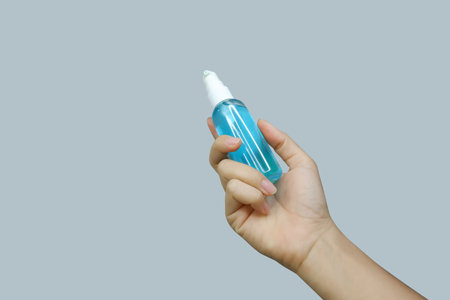 Asian woman's hand holding a sanitizerの写真素材