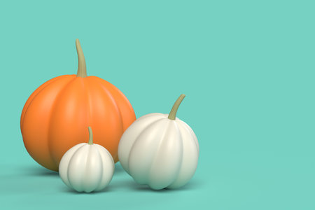 Three pumpkins isolated on greenの写真素材