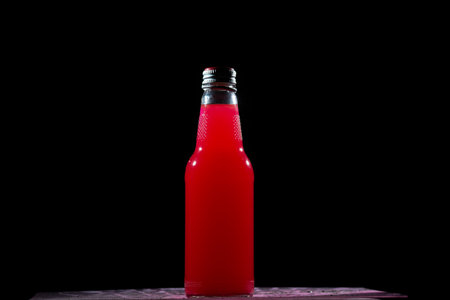 red bottle on dark backgroundの写真素材