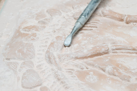 digging dinosaur clay with archeology tools