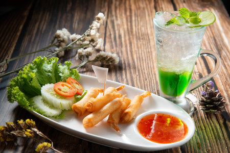 shrimp warp or ebi roll deep dry in white ellipse dish fill with spicy source decorate by slice...