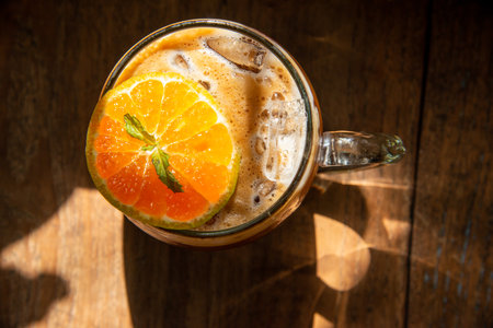 espresso shot mixed with soda on bottom in transperant glasses mug with coffee bubble topping by...