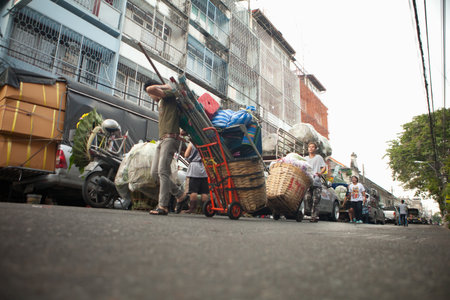 Bangkok, Thailand - October 19,2012: Workers haul equipment and supplies to vending stalls at a market in Bangkok, Thailand.のeditorial素材