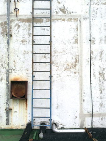 weathered stucco wall with iron staircase backgroundの写真素材