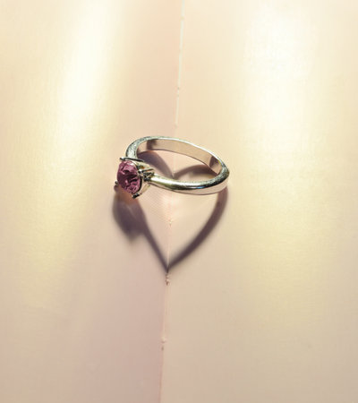 Love concept with a heart shadow of a ring on book pageの写真素材