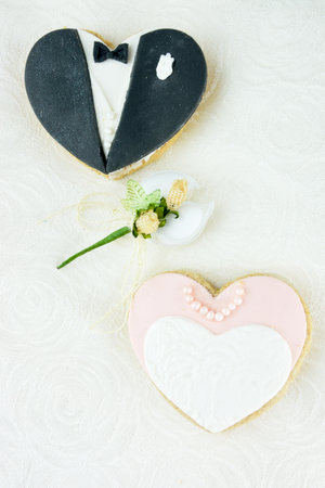 Heart shaped dress and tux cookies and sugared almondsの写真素材
