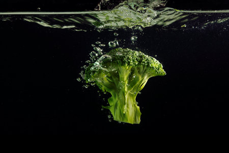 Broccoli splash on black backgroundの写真素材