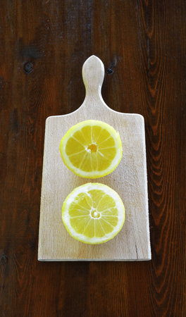 Halves of lemon on a wooden boardの写真素材