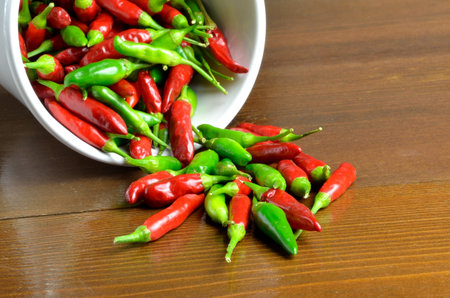 Red and green hot chili peppers  on wooden table