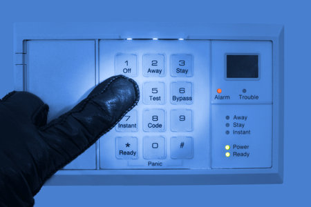 Cracking and disarming a burglar alarm systemの写真素材