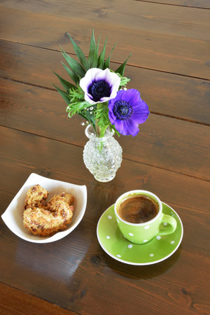 Green spotty mug, cookie and vase with anemoneの写真素材