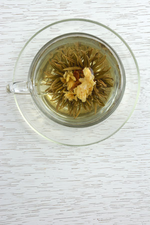 Cup of blooming tea served in glass teacupの写真素材