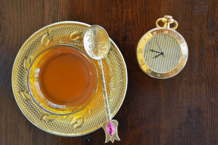Turkish teacup with spoon and antique pocket watchの写真素材