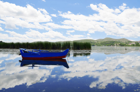 Blue wooden boat on the lakeの写真素材