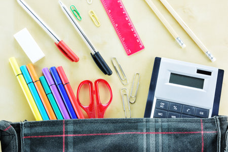 Bag and scool supplies on wooden background