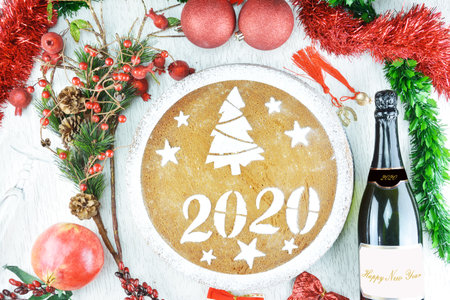 Concept with traditional Greek new year's cake,vasilopita, a bottle of champagne,a class ,a...