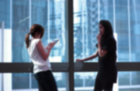 Blur two women talkingの写真素材