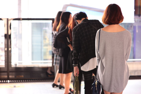 Women wait for train with blur background