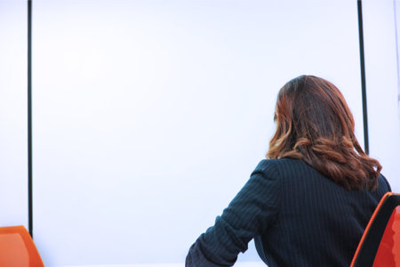 Working women sit on orange chair  in meeting roomの写真素材