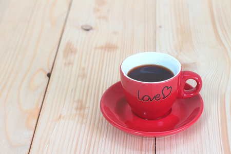 Red coffee cup on wood plate , valentine day concept.の写真素材