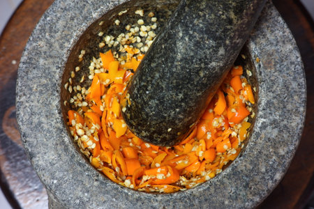 Blending yellow chilli in motar.の写真素材
