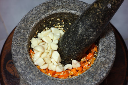 Blending yellow chilli in motar.の写真素材