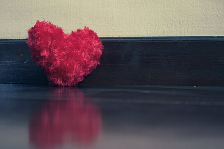 Red heart on wood plate