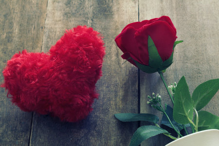 Red rose and two white teddy bears and heart on wood plate.の写真素材