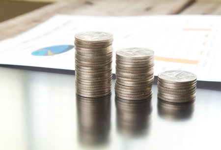 Close-up stack of money with paper document on background の写真素材