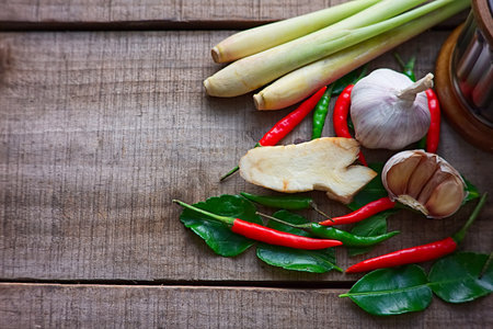 Galangal and lemongrass and chili and garlic and ginger on the wood table in thai kitchen on right frame , have space for text の写真素材