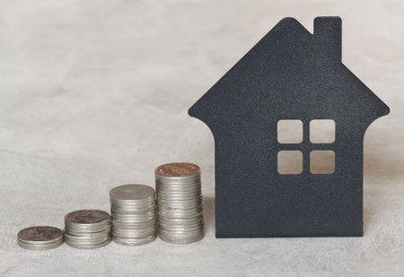 Stack of coin and house modelの写真素材