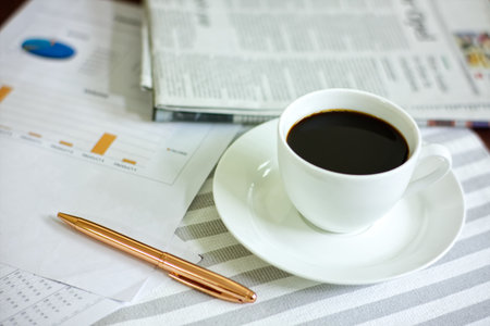 Coffee cup on working table in the morning の写真素材