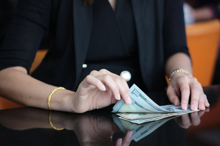 Women check bank note.の写真素材