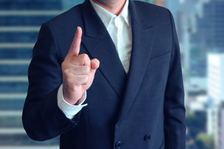Business man point finger up with blur background business area.の写真素材