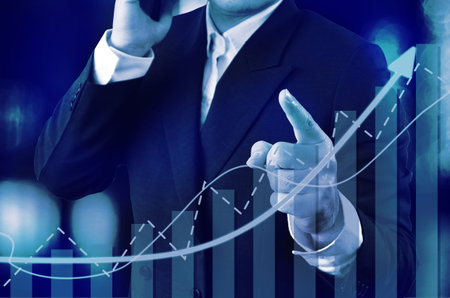 Chart direction up trend and volump with background  business man point finger.の写真素材