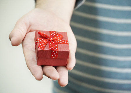 Hand give red gift boxの写真素材