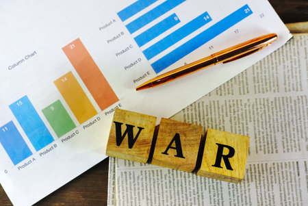 Top lay out view text WAR on wood cube block lay on newspaper near chart paper and gold pen,world...