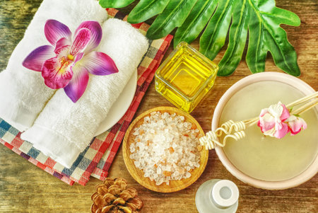 Topview himalaya salt and aroma oil and candle and towel on wood table,aroma spa set concept.