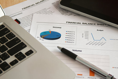 Financial paper and work station with tablet on working table, business concept.