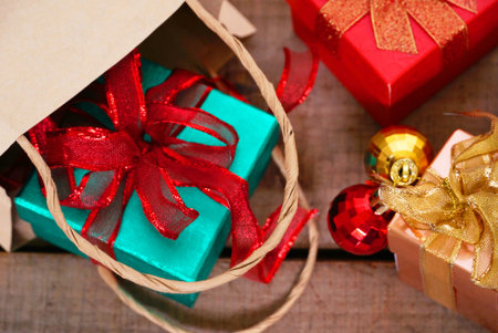 Gift boxes spill out from bag on the tableの写真素材