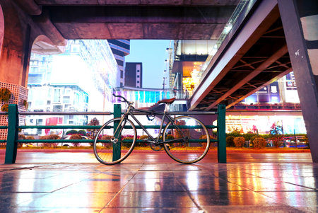 Bicycle park on footpath with street traffic backgroundの写真素材