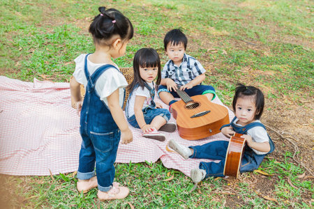 Cute Baby Boy and Girls 2-3Year Old play on Picnic Blanketの写真素材