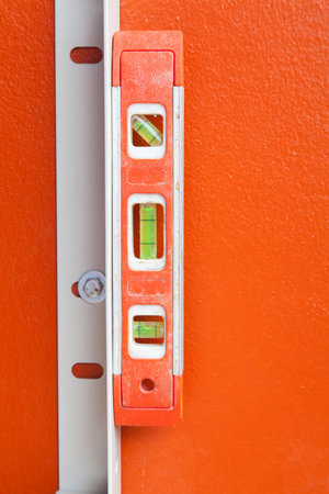 Orange Color of Construction Water Level Using on orange wall